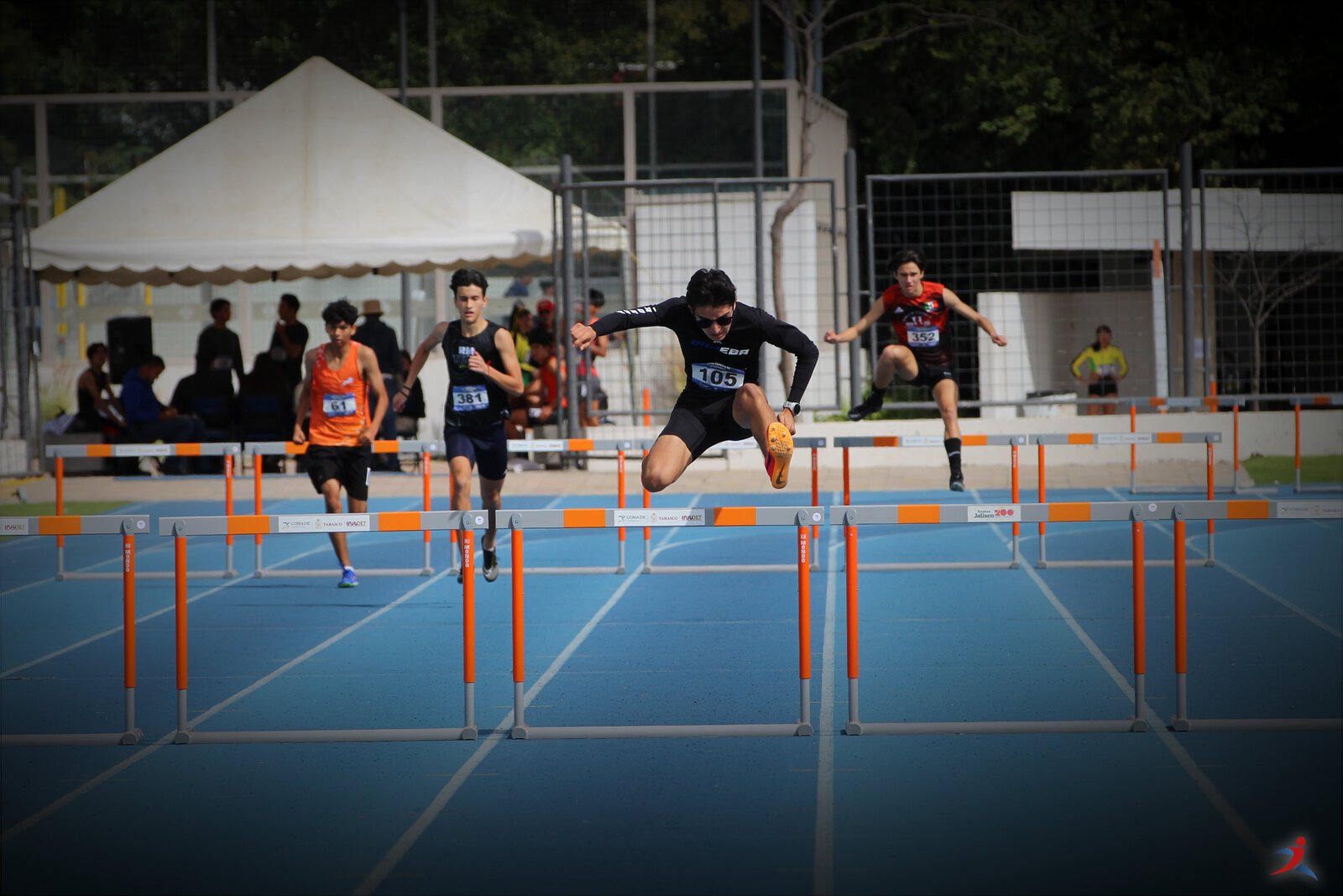 Leonardo Fernández clearing hurdles mid-race