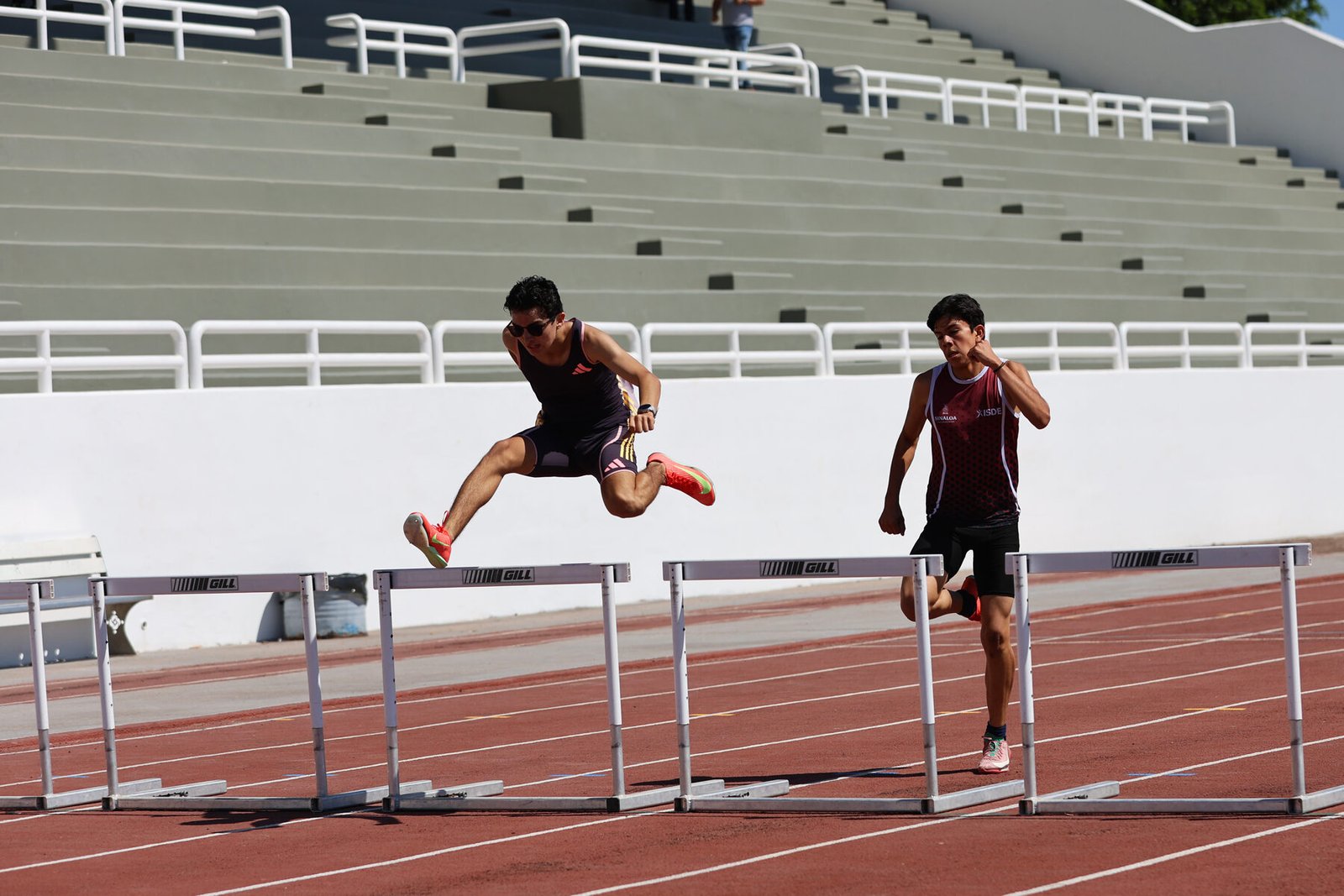 Leonardo Fernández clearing a hurdle in competition